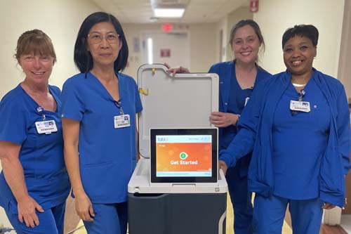 Picture of team with a dialysis machine